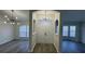 Inviting foyer featuring modern light fixtures and sleek, gray laminate flooring at 403 Britten Dr, Kissimmee, FL 34758
