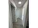 Hallway with multiple doorways and light gray vinyl flooring at 403 Britten Dr, Kissimmee, FL 34758