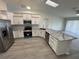 Bright kitchen with stainless steel appliances, granite countertops, and a large island at 403 Britten Dr, Kissimmee, FL 34758