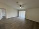 Spacious living room with gray laminate flooring and sliding glass doors at 403 Britten Dr, Kissimmee, FL 34758