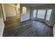 Open living room with gray laminate flooring and ample natural light at 403 Britten Dr, Kissimmee, FL 34758
