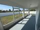 Enclosed outdoor patio with screen windows overlooks fenced backyard and plenty of sunlight at 403 Britten Dr, Kissimmee, FL 34758