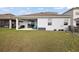 Spacious backyard with a covered patio, offering an ideal space for outdoor entertaining and relaxation at 4439 Davos Dr, Clermont, FL 34711