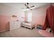 Charming bedroom featuring playful decor, pink accents, and a comfortable bed at 4439 Davos Dr, Clermont, FL 34711
