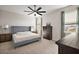 Spacious bedroom with ceiling fan, ensuite bath, and large windows for natural light at 4439 Davos Dr, Clermont, FL 34711