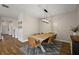 Modern dining room with wood table, leather chairs, statement light fixture, and accent rug at 4439 Davos Dr, Clermont, FL 34711