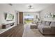 Bright living room featuring a large sliding glass door, modern furnishings, and luxury vinyl floors at 4439 Davos Dr, Clermont, FL 34711