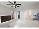 Spacious main bedroom with ceiling fan, ensuite bathroom, and dark wood dresser at 4439 Davos Dr, Clermont, FL 34711