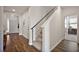 Bright entryway with a staircase featuring carpeted steps and wood flooring, plus an entrance to another room at 4439 Davos Dr, Clermont, FL 34711