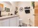 A half bath featuring a vanity, decorative mirror and toilet at 4451 Seawater Street, Orlando, FL 32812