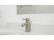 Bathroom vanity featuring white countertop, modern fixture, and brushed metal faucet at 4765 Sw 128Th St, Ocala, FL 34473