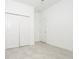 Bedroom featuring tile floors, white walls, and a pair of white closets at 4765 Sw 128Th St, Ocala, FL 34473