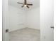 Bedroom featuring tile floors, white walls, ceiling fan, and a window at 4765 Sw 128Th St, Ocala, FL 34473