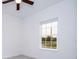 Bright bedroom features a window with blinds and a ceiling fan at 4765 Sw 128Th St, Ocala, FL 34473