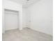 Bedroom featuring tile floors, white walls, and an open door to the closet at 4765 Sw 128Th St, Ocala, FL 34473