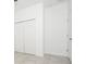 Hallway featuring tile floors, white walls, and a pair of white closets at 4765 Sw 128Th St, Ocala, FL 34473