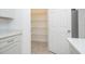View into the walk-in pantry featuring bright lighting and wire shelving for organized storage at 4765 Sw 128Th St, Ocala, FL 34473