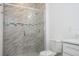 Shower featuring sliding glass door, brushed metal fixture, and marble tiling at 4765 Sw 128Th St, Ocala, FL 34473