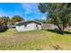 Spacious backyard with lush lawn and mature trees providing shade and privacy at 4915 Pocahontas Ln, Lakeland, FL 33810