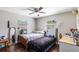 Bright bedroom with wood floors featuring two twin beds, a ceiling fan, and a workspace at 4915 Pocahontas Ln, Lakeland, FL 33810