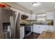 Modern kitchen with stainless steel appliances, white cabinets, and granite countertops, perfect for cooking at 4915 Pocahontas Ln, Lakeland, FL 33810