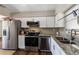 Well-equipped kitchen with stainless steel appliances, white cabinets, and sleek countertops at 4915 Pocahontas Ln, Lakeland, FL 33810