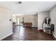 An open-concept living area featuring wood floors and bright lighting leading into the dining area at 4915 Pocahontas Ln, Lakeland, FL 33810