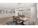 Elegant dining area with a large wooden table, stylish chairs, and modern lighting at 5898 Soter Ln, Windermere, FL 34786