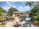 Backyard featuring a patio, pond, and seating at 6 Winding Ridge Rd, Casselberry, FL 32707