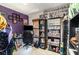 Bedroom with shelves, desk, and purple accent wall at 6 Winding Ridge Rd, Casselberry, FL 32707