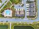 Aerial view of a townhome neighborhood featuring a community pool, ponds, and walking trails at 6024 Soter Ln, Windermere, FL 34786