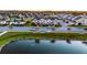 Beautiful aerial shot of townhomes overlooking a serene pond and community area at 6024 Soter Ln, Windermere, FL 34786