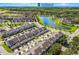 Expansive aerial shot of a residential neighborhood featuring a lake, community, and well-maintained landscaping at 6024 Soter Ln, Windermere, FL 34786