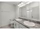 Bright bathroom with double sinks, granite countertops, and walk-in shower at 6024 Soter Ln, Windermere, FL 34786