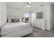 Bright bedroom features neutral decor, ceiling fan, and dresser with large mirror at 6024 Soter Ln, Windermere, FL 34786