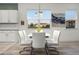Eat-in kitchen features updated white cabinets, granite countertops, and a large dining table with seating at 6024 Soter Ln, Windermere, FL 34786