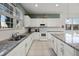Bright kitchen features updated white cabinets, granite countertops, and stainless steel appliances at 6024 Soter Ln, Windermere, FL 34786
