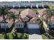 Aerial view of a single-story home featuring a tile roof, two-car garage, and landscaping within a residential community at 631 Tuscan Hills Blvd, Davenport, FL 33897