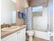 A bathroom with a single sink vanity, toilet, and shower-tub combination, with a small window for natural light at 631 Tuscan Hills Blvd, Davenport, FL 33897