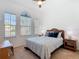 Bedroom featuring natural light from large windows, ceiling fan, with a queen size bed at 631 Tuscan Hills Blvd, Davenport, FL 33897