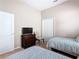 Bedroom furnished with two twin beds, a dresser, closet, and a chair for relaxation at 631 Tuscan Hills Blvd, Davenport, FL 33897