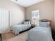 Bright bedroom with twin beds, closet space, and a window providing natural light at 631 Tuscan Hills Blvd, Davenport, FL 33897