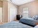 Bedroom with two twin beds, a dresser, closet, and a window offering natural light and ventilation at 631 Tuscan Hills Blvd, Davenport, FL 33897