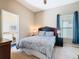 Cozy bedroom featuring a queen-sized bed, ceiling fan, and an attached bathroom offering additional convenience at 631 Tuscan Hills Blvd, Davenport, FL 33897