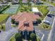 Aerial view of community center with amenities: tennis court, playground, and ample parking at 631 Tuscan Hills Blvd, Davenport, FL 33897