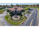 Community clubhouse featuring well-maintained landscaping, a fountain, and convenient parking at 631 Tuscan Hills Blvd, Davenport, FL 33897