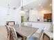 View of the dining room shows a light fixture, view of the kitchen, and a foosball table at 631 Tuscan Hills Blvd, Davenport, FL 33897