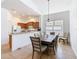 Comfortable dining room featuring a large wood table, seating for six, and a view into the kitchen at 631 Tuscan Hills Blvd, Davenport, FL 33897