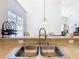 Open kitchen features a breakfast bar overlooking the living area, with a double sink and ample countertop space at 631 Tuscan Hills Blvd, Davenport, FL 33897