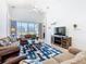 Comfortable living room featuring plush sofas, a patterned rug, and natural light from large windows at 631 Tuscan Hills Blvd, Davenport, FL 33897